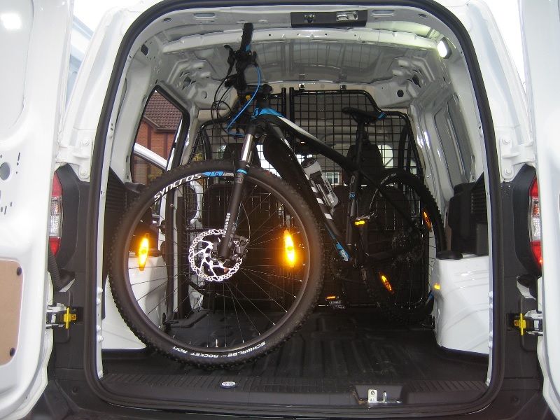 A dedicated van courier with a secured bike ready for transport